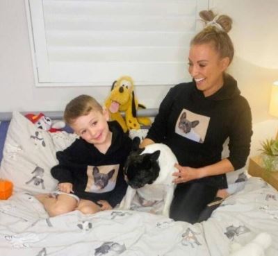 Harvey Glenn Watts with his mother Rachel Watts and pet Charlie, wearing jumper with the print of their dog